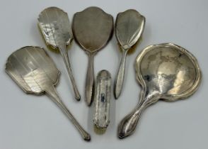 Hallmarked silver backed dressing table items to include three mirrors, two hairbrushes and a