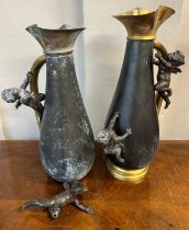 A pair of brass and spelter vases with cherub decoration. 40cm h.