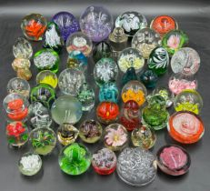 A large collection of paper weights, various colours, shapes and sizes named ones to include T.V.G.,