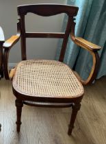 A cane seated armchair. Marked J&J Kohn to underside.