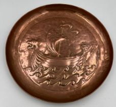 Keswick school copper wall plate by W.H Mawson embossed with a Viking ship, 20.5cm d,