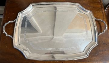 A two handled silver tray with engraved band, Sheffield 1924, maker Mappin and Webb Ltd. Weight