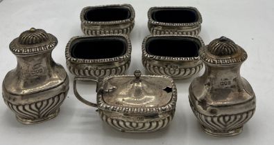 Hallmarked silver to include four blue glass lined salts, Birmingham 1908, two pepperettes and a