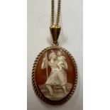 A carved shell cameo depicting St. Christopher set in 9 carat gold on a 9 carat gold chain. Weight