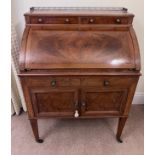 A 19thC cylinder topped writing table with inlays and white metal brass gallery and knobs. 74 w x 47