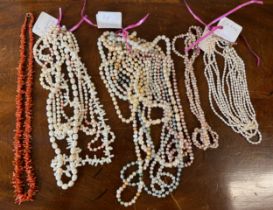 A large quantity of pearl bead necklaces together with a coral necklace.