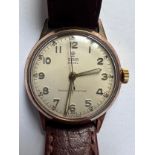 A 1950's Tudor Royal 9ct gold wristwatch on camel grain leather strap. Stamped to inner case