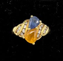 An 18 carat yellow gold ring set with blue and yellow sapphires with diamonds. Size M, weight 5.1gm.
