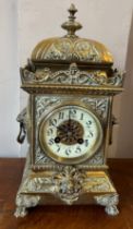 An ornate brass mantle clock with white enamel face. Presented to Lieut. D Blair by the NCO’s and