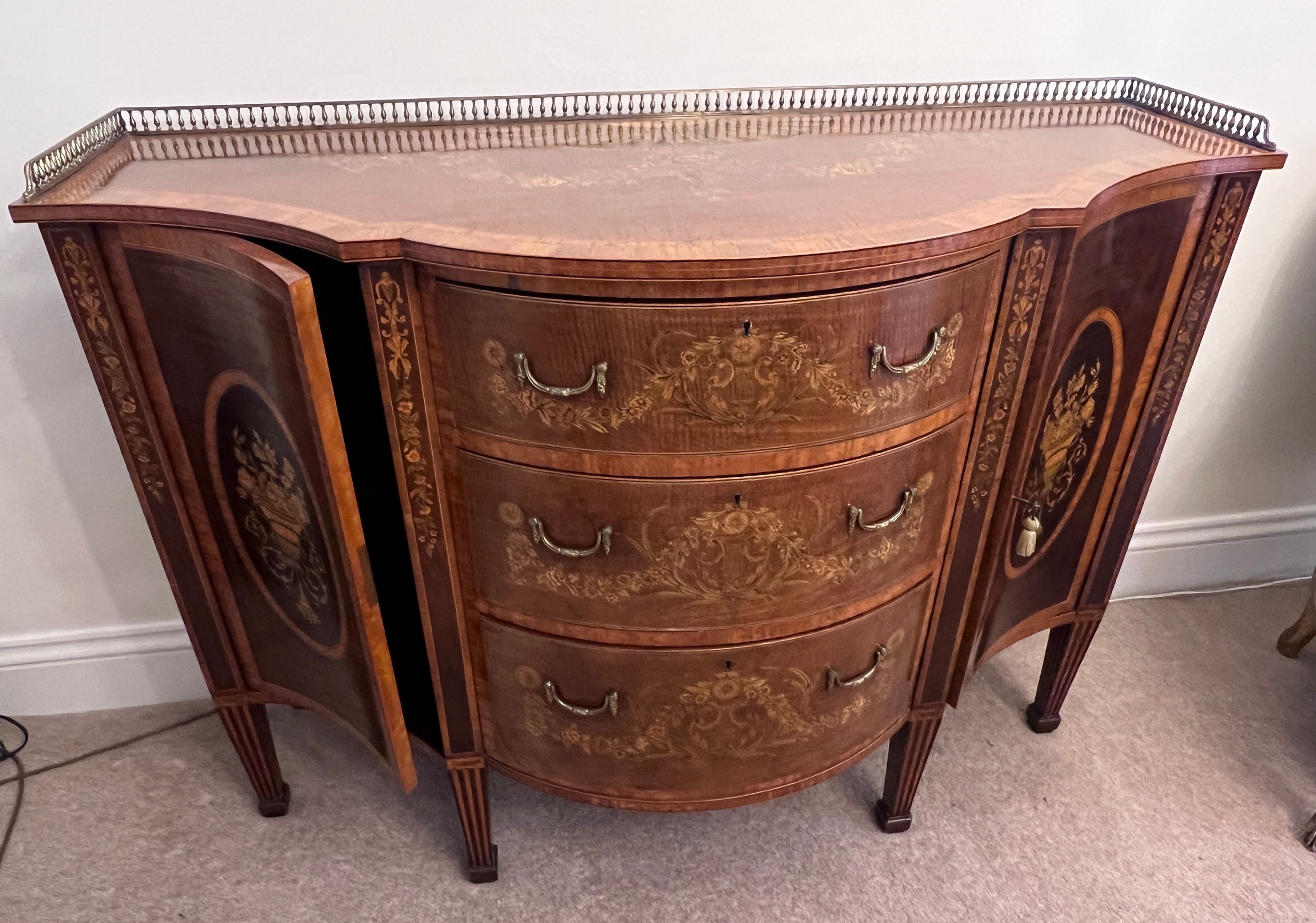 A 19thC continental fine quality breakfront marquetry side cabinet with various woods including