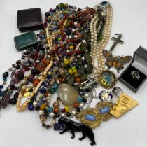 A quantity of vintage costume jewellery and boxes to include glass and other beads, brooches,