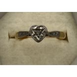 An 18 carat and platinum heart shaped ring set with diamond chip. Size J/K. Weight 1.9gm.