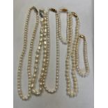 Four pearl necklaces and two bracelets. One necklace with 14 carat gold clasp and a bracelet with an