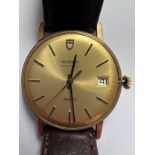 A gentleman's Tudor Geneve quartz 9ct gold wristwatch on brown leather strap with date aperture,