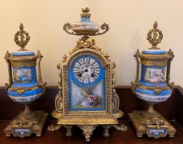 A French gilt metal mantle clock with a painted porcelain face, case back stamped P.H. Mourey 74,