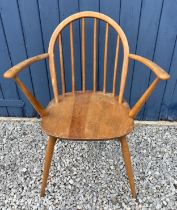 A mid century Ercol carver chair with original blue paper label.