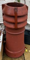 A 19thC red terracotta chimney pot. 71cm h.