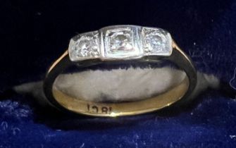 An 18 carat gold ring set with 3 diamonds. Size M. Weight 2.5gm.