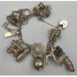 A silver charm bracelet with 15 charms, some marked silver. Total weight 62.7gm.