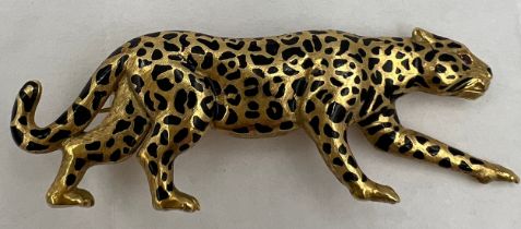 A 18 carat gold leopard brooch with ruby eyes and black enamelled decoration Weight 9.1gm. 5cm l.