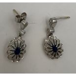 A pair of 18 carat white gold diamond and sapphire drop earrings. Weight 3.8gm.