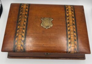 A 19thC mahogany book shaped writing/stationary box inlaid with Tunbridge ware bands. 26cm x 19cm