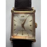 A 14ct gold Longines wristwatch on black leather strap. Case 24mm. Stamped to inner case Longines 14