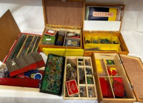 A collection of vintage Meccano parts, various loose items in wooden storage boxes including wheels,