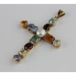 A gold and vari-coloured gem stone set pendant cross mounted with a cultured pearl to the centre,