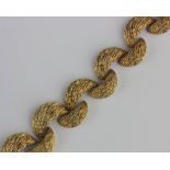 An 18ct gold collar necklace designed as a series of crescent shaped links having a bark textured