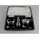 A Queen Elizabeth II cased silver three piece cruet set of salt, mustard and pepper pot with two