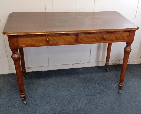 A Victorian mahogany side table rectangular top with rounded corners above two drawers on turned