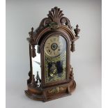 A 19th century American Ansonia Clock Company carved walnut mantle clock, 62.5cm high, with keys