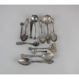 A Tiffany sterling silver teaspoon with shell and scroll terminal, four similar teaspoons with