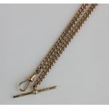 A 9ct gold curb link watch Albert chain fitted with a 9ct gold swivel and with a 9ct gold T bar,