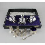 A pair of George V silver salt and mustard cruets with scroll handles and blue glass liners with a