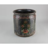 A painted carved wooden pot, with floral decoration on black ground 25cm high, 24cm diameter