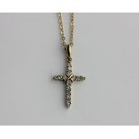 A gold and diamond pendant designed as a cross detailed 9k, with a gold neck chain, detailed 750, on