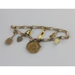 A 9ct gold bracelet fitted with a George V half sovereign 1914 in a 9ct gold pendant mount, and six,