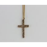 A 9ct gold pendant cross with scroll engraved decoration, Birmingham 1971, with a gold curb link