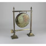 A brass dinner gong on brass stand, with striker width 29cm, height 37cm