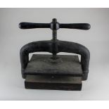 A cast iron book press width 41cm, height approx 40cm