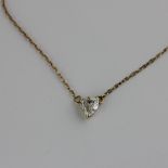 A gold and diamond single stone heart shaped pendant necklace, the heart shaped diamond pendant