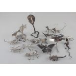 A collection of Indian novelty white metal place settings in the form of various animals and