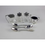 An Art Deco silver three piece silver topped glass cruet set of salt, pepper and mustard pots, maker