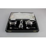 A Queen Elizabeth II cased silver three piece cruet set of salt, mustard and pepper pot with two