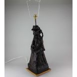 A carved wood figure of a mother a child converted to a table lamp, 58.5cm high including brass