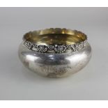 An American sterling silver circular bowl with raised floral cast border, stamped Bigelow, Kennard &