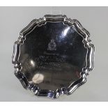 A George VI silver salver with pie crust border on four scroll feet, presentation inscription to Mrs