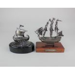 A 925 silver model of a ship mounted on oval wooden stand, ship approx 8.5cm high, together with a